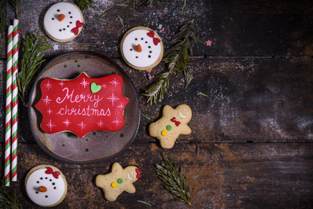 Merry Christmas gingerbread cookies on the wooden background with blank spaceの写真素材