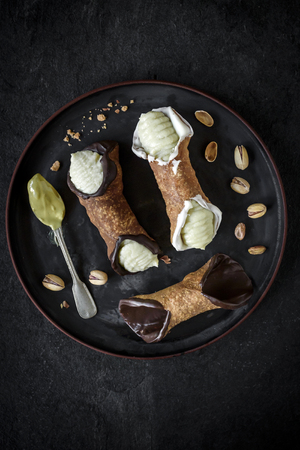 Traditional Sicilian dessert called cannoli with creamの写真素材