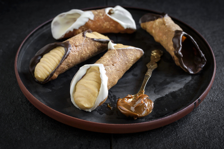 Traditional Sicilian dessert called cannoli with creamの写真素材