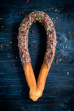 Traditional Spanish snack churros with toppingsの写真素材