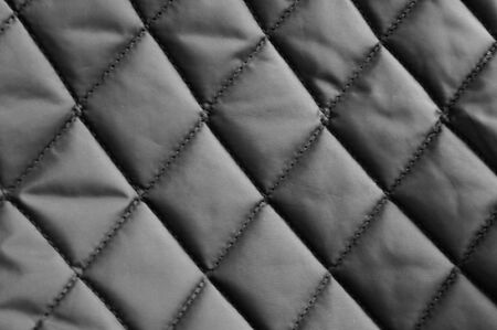 texture of dark gray quilted fabric for background and letteringの写真素材