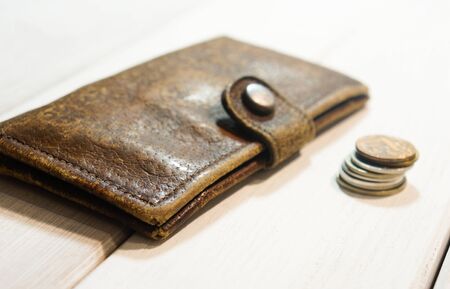 old leather wallet with a trifle, no money, waiting for a salary, inflation