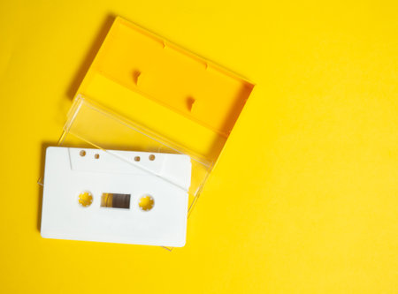 Audio tape. Vintage white audio tape with yellow background.