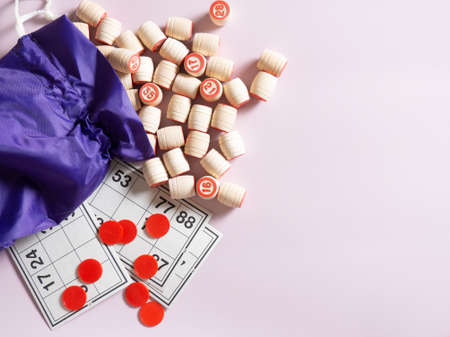Wooden kegs of lotto, playing cards for playing lotto with a bag on a pale lilacの写真素材