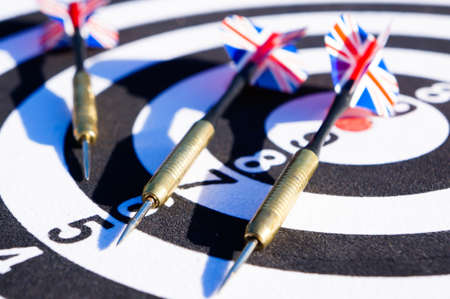 Darts with colored arrows top view, darts on the target.