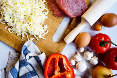 pizza ingredients are scattered on a white table copy spaceの写真素材