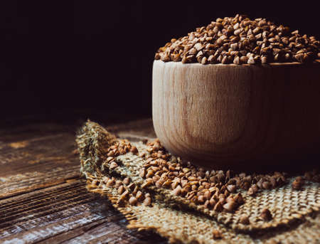 buckwheat in a wooden bowl on the tableの写真素材