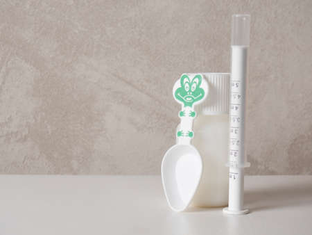 children's suspension with a syringe and a spoon