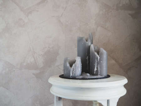 burnt large candles on a concrete background, a copy spaceの写真素材