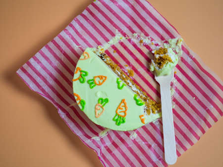 Small cake, a piece of cake on a wooden fork on a yellow background, isolated