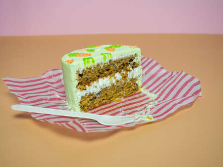 Small cake, a piece of cake on a wooden fork on a yellow background, isolatedの写真素材
