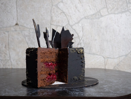 modern black square chocolate cake covered with velor and decorated with isomalt and chocolate bar