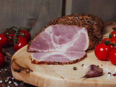 The meat is carbonated in spices and seasonings on an old wooden background. The concept of a meat delicacy.copy of the spaceの写真素材