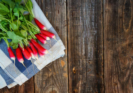 fresh greens from the garden radish on a wooden background with place for your text, concept of healthy eatingの写真素材
