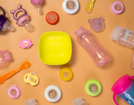 baby food supplies, various bottles, teats, spoons and plates.the concept of baby food and child...