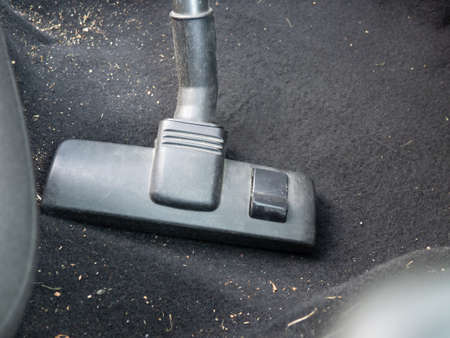 inside the car cleaning with a vacuum cleaner close-upの写真素材