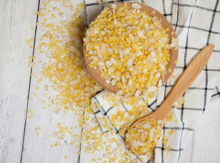 breakfast cereal mixture of several grains in a wooden spoonの写真素材