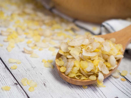 breakfast cereal mixture of several grains in a wooden spoon
