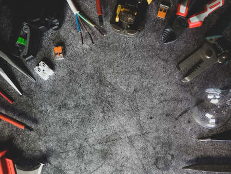 Flat lay composition with electrician's tools and space for text on gray concrete backgroundの写真素材