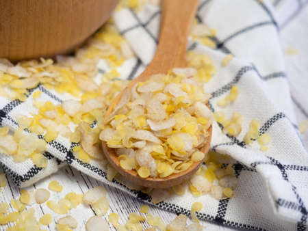 breakfast cereal mixture of several grains in a wooden spoon