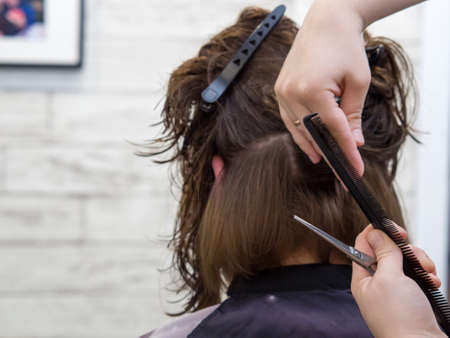 girl gets a new hairstyle in a beauty salon. professional hair styling.の写真素材