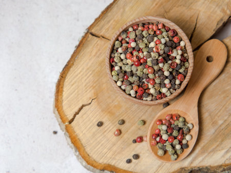 Pepper mix. Black, red, green, white peppercorns spices, Mix of different peppers in a wooden spoon