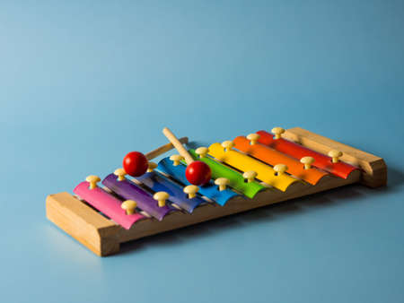 colorful educational xylophone toy on a blue background with copy space. Children's toy and musical instrument.の写真素材