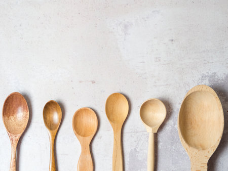 Wooden spoons made of natural wood on a light background. Natural natural materials. Caring for the environmentの写真素材