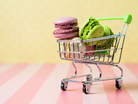 Fresh baked colored macaroon cookies macarons, macarons on a white plate close-up,の写真素材