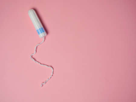 female tampon on a pink background. Hygienic white tampon for women. Cotton swab. Menstruation, Tampons on a pink background.の写真素材