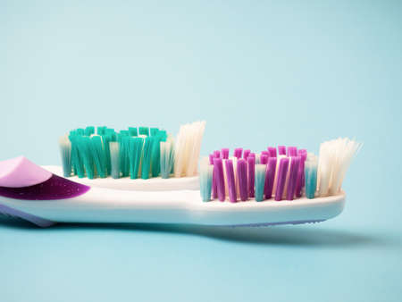 old toothbrushes on a blue background .used male and female toothbrushes