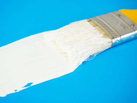 brush with white paint draws space for text on blue backgroundの写真素材