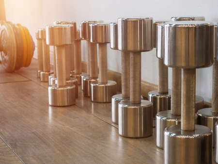 Rows of dumbbells in the gym. Rack with heavy dumbbells in a fitness club. Workout bodybuilding concept.の写真素材