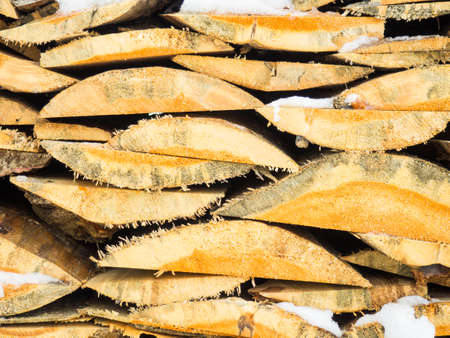 firewood natural background. Quarters of firewood are stacked in a pile, a background of firewoの写真素材