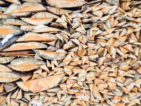 firewood natural background. Quarters of firewood are stacked in a pile, a background of firewoの写真素材