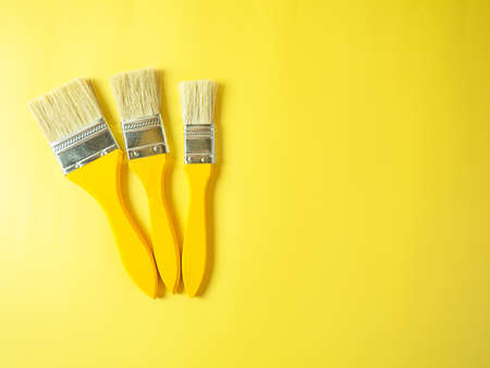 brushes for paint on a yellow backgroundの写真素材