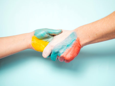 hand with the flag of ukraine shakes hands with the flag of russia .no warの写真素材