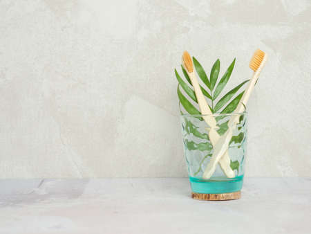 Natural bamboo toothbrushes in a glass jar. dental care, plastic free concept. Copy space for textの写真素材