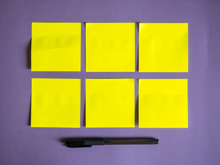 blank yellow sticky notes on purple backgroundの写真素材