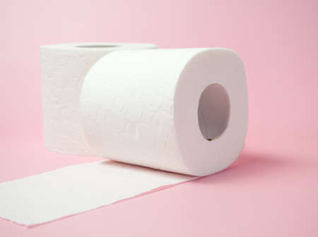 Toilet paper roll on pink background, Space for text