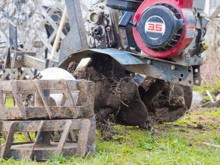 Spring preparation of the soil for sowing by a cultivator. close-up photo of a cultivator, preparation for planting a crop,の写真素材