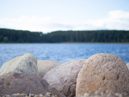 large granite boulders on the banks of the river close-upの写真素材