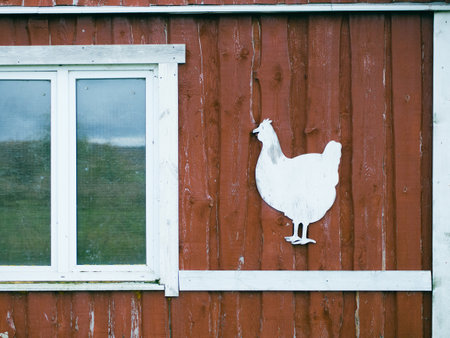 Red rustic wooden chicken coop facade. with chicken stencil for text, farming conceptの写真素材