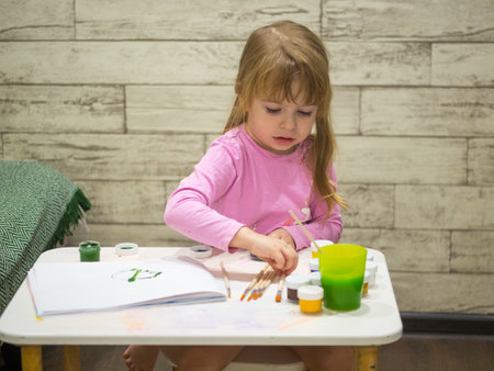 little girl draws with paints.の写真素材