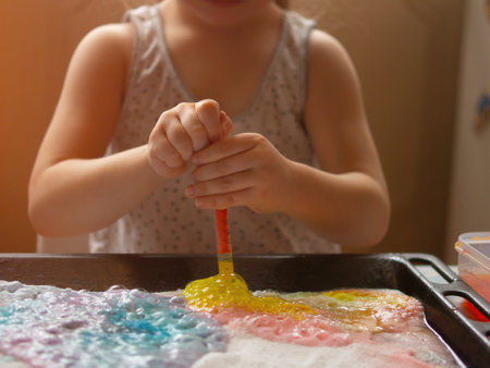 a child makes experiments with chemicals. experiments with soda and citric acidの写真素材