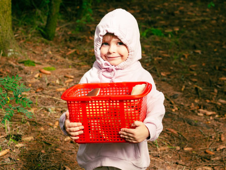 girl in the forest shows red mushroomの写真素材
