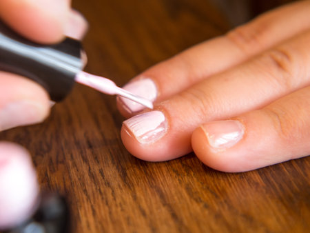 girl paints her nails with polishの写真素材