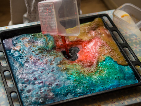 a child makes experiments with chemicals. experiments with soda and citric acidの写真素材