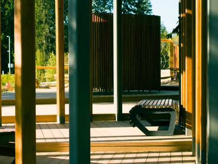 modern wooden city park on the river bank surrounded by forestの写真素材