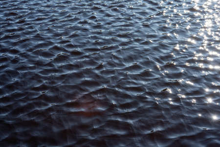 Texture of water surface with ripples and sunlight. Abstract background.の写真素材